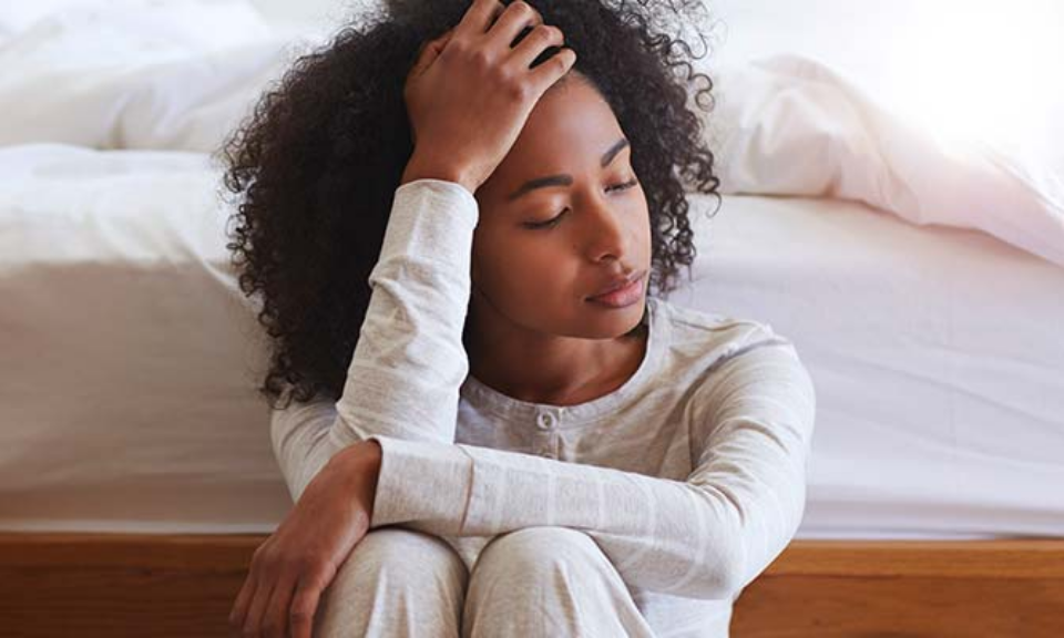 Person sitting on floor thinking